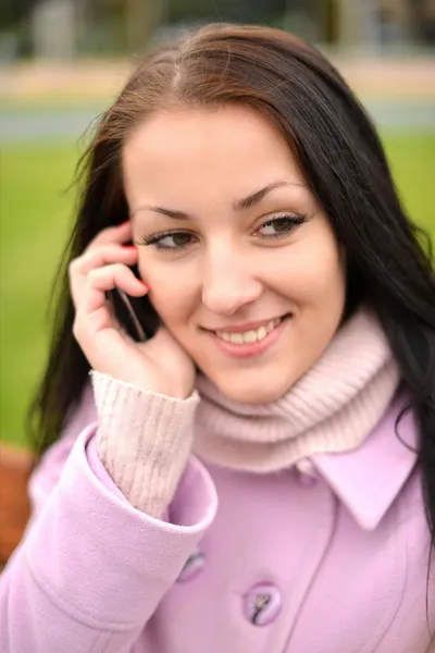 Beautiful young woman with mobile cell phone in city. Closeup, copyspace. — Stock Photo, Image