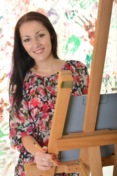 Beautiful woman painting with a paintbrush — Stock Photo, Image