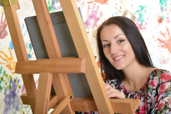 Beautiful woman painting with a paintbrush — Stock Photo, Image