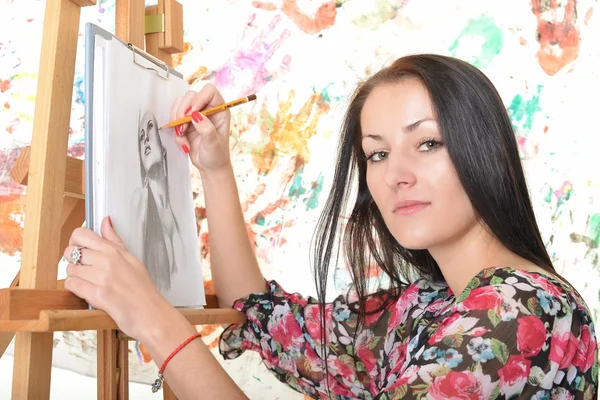 Beautiful woman painting with a paintbrush — Stock Photo, Image