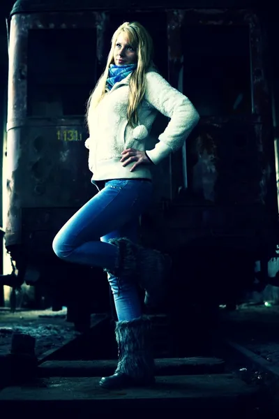 Young woman standing near a train — Stock Photo, Image