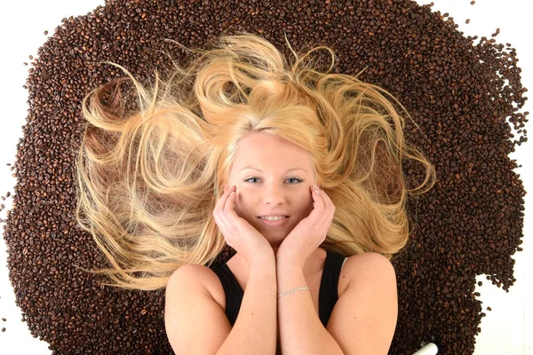 Ritratto del viso di una ragazza annegato nei chicchi di caffè — Foto Stock