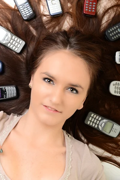 Portrait of happy woman with mobile phones — Stock Photo, Image