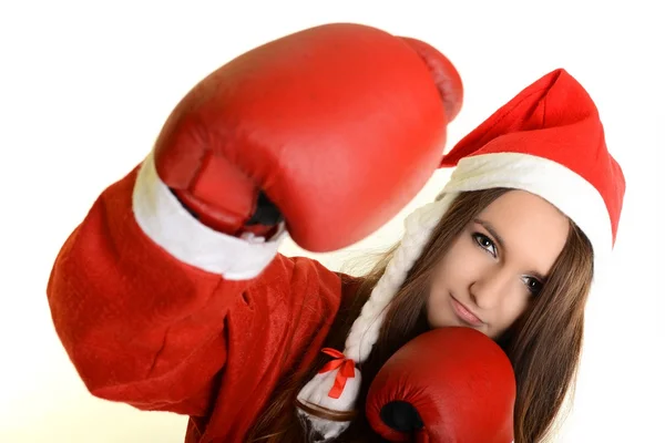 Christmas woman hitting wearing boxing gloves and red santa hat — Stock Photo, Image