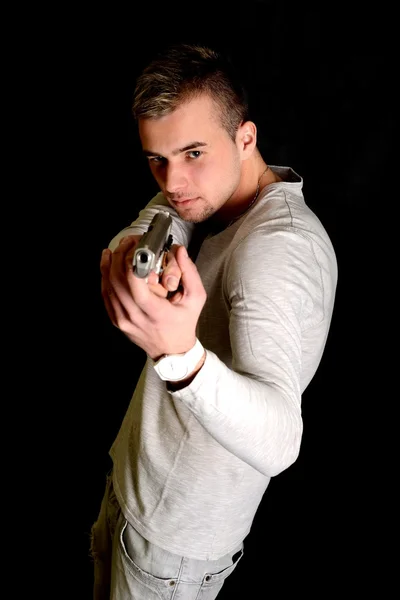 Young man with gun — Stock Photo, Image