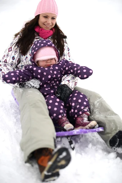 Madre e hija trineo, escena de invierno agradable —  Fotos de Stock