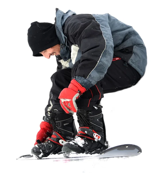 Ung man som försöker åka snowboard — Stockfoto
