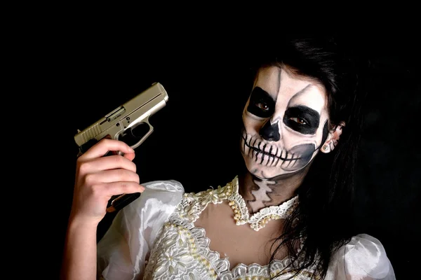 Girl with painting dead mask skull with gun — Stock Photo, Image