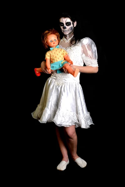 Girl with painting dead mask skull with doll — Stock Photo, Image