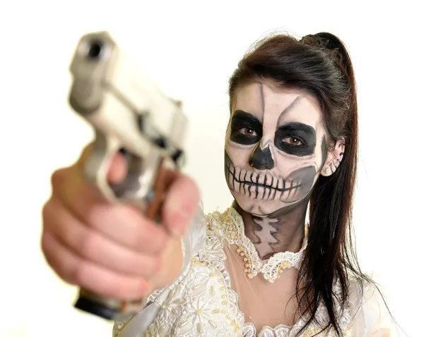 Girl with painting dead mask skull with gun — Stock Photo, Image