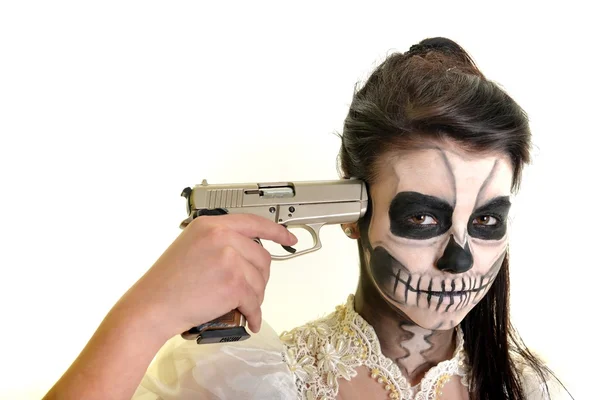 Girl with painting dead mask skull with gun — Stock Photo, Image