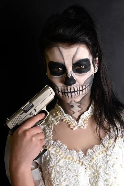 Girl with painting dead mask skull with gun — Stock Photo, Image