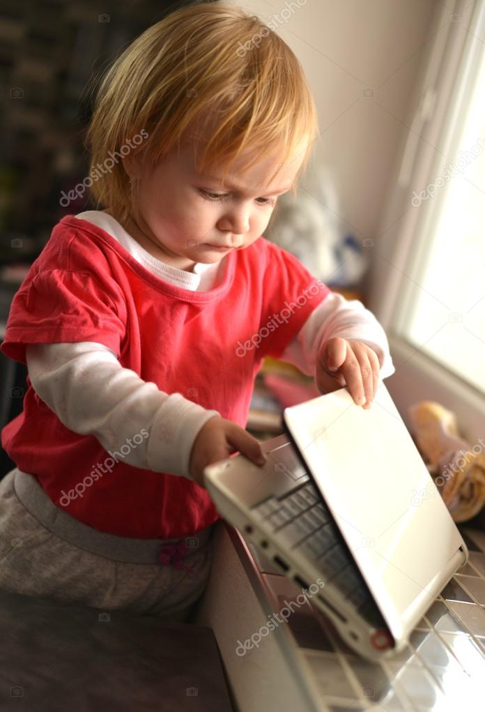 Cute child using laptop