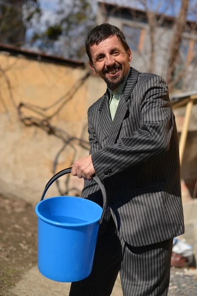A man with a bucket of water — Stock Photo, Image