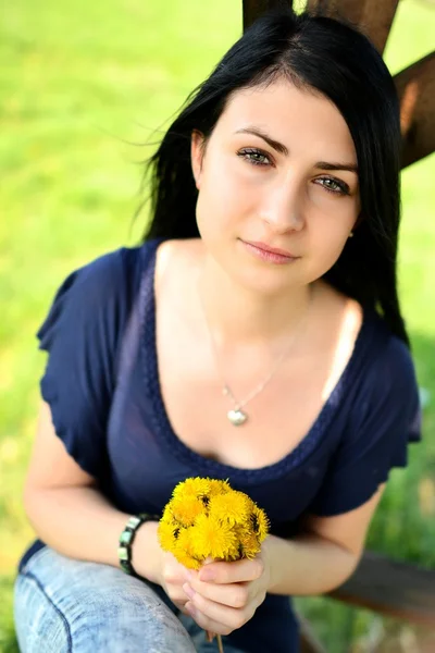 Beautiful woman with dandelion — Stock Photo, Image