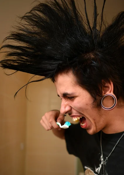 Punk boy brushes his teeth — Stock Photo, Image