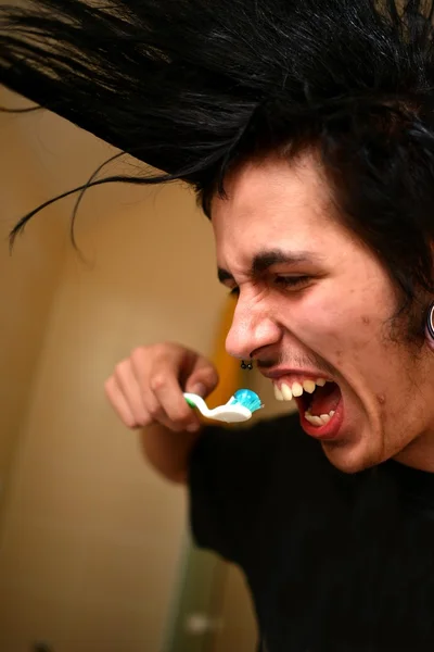 Punk boy brushes his teeth — Stock Photo, Image