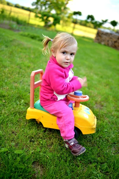 Leuk meisje in een kleine auto — Stockfoto