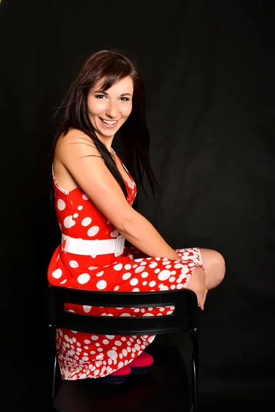 Young woman sitting on a chair — Stock Photo, Image