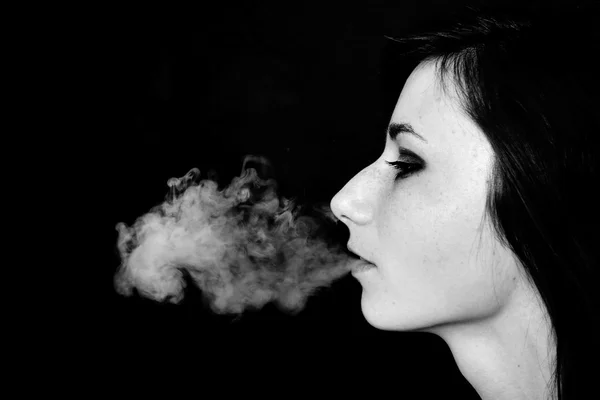 Женщина курит электронную сигарету — стоковое фото