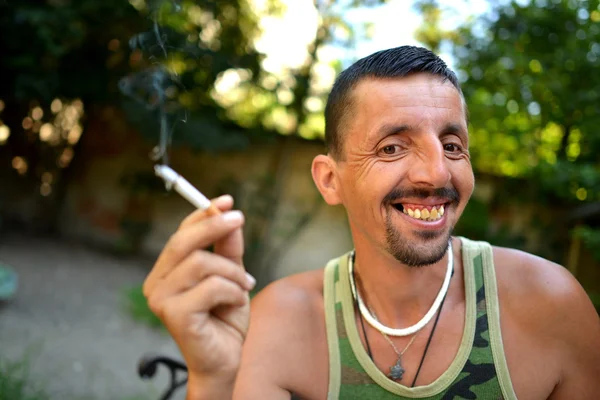 Man sitting and smoking cigarette — Stock Photo, Image