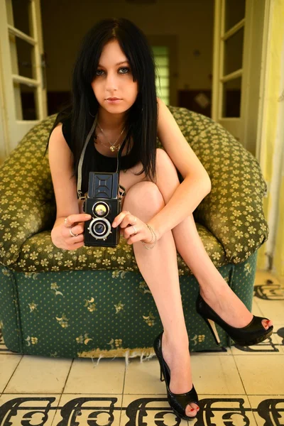 Sexy girl sitting on a luxury sofa — Stock Photo, Image