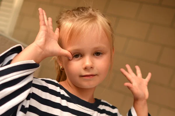 Retrato de una linda niña vestida con un chaleco despojado — Foto de Stock