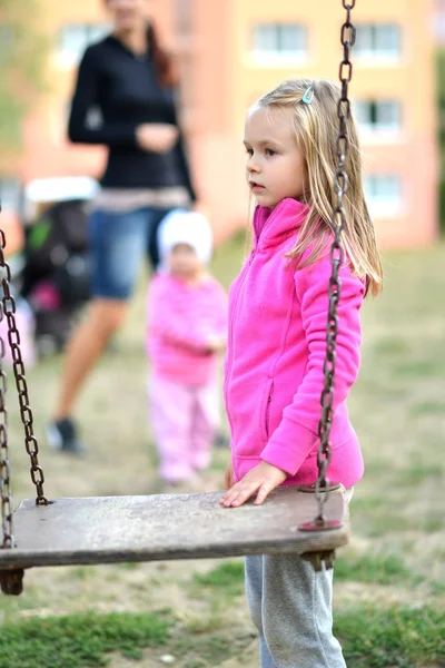 Kleines Mädchen spielt auf der Schaukel — Stockfoto