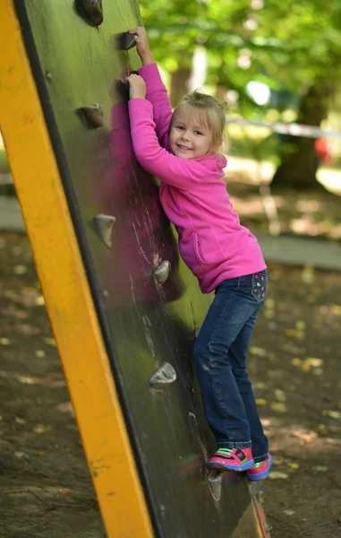 Menina jogar em um parque infantil — Fotografia de Stock