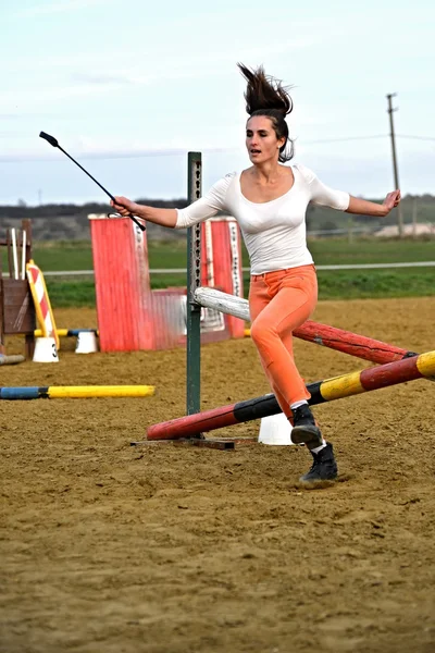 Woman jumping barrier — Stock Photo, Image