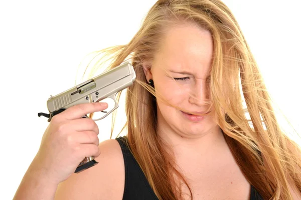 Young beautiful woman holding a gun — Stock Photo, Image