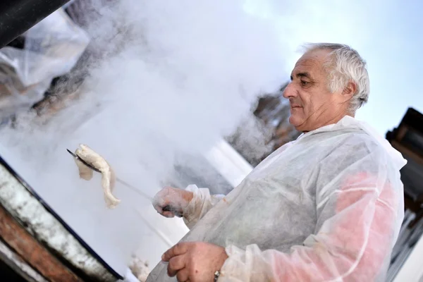 Muž vaří maso — Stock fotografie