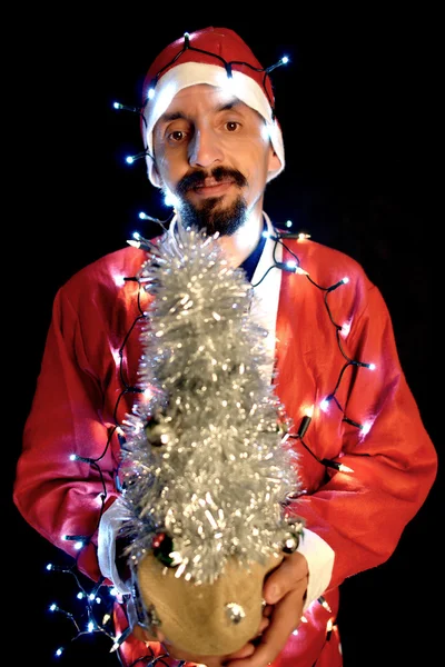 Tema de Natal com Santa segurando luzes mágicas nas mãos — Fotografia de Stock