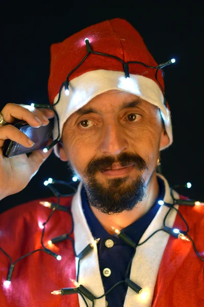 Santa bedrijf magische lichten in handen — Stockfoto