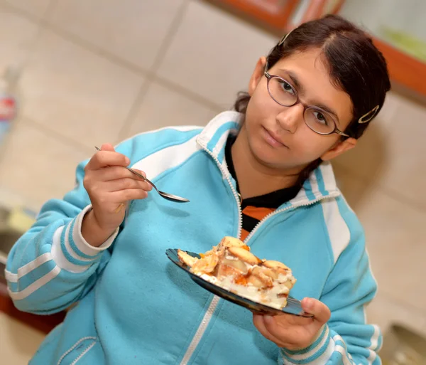 Uma menina com apetite para comer sobremesa — Fotografia de Stock