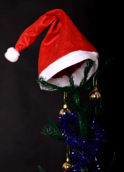 Christmas background decorated tree with santa hat on it — Stok fotoğraf