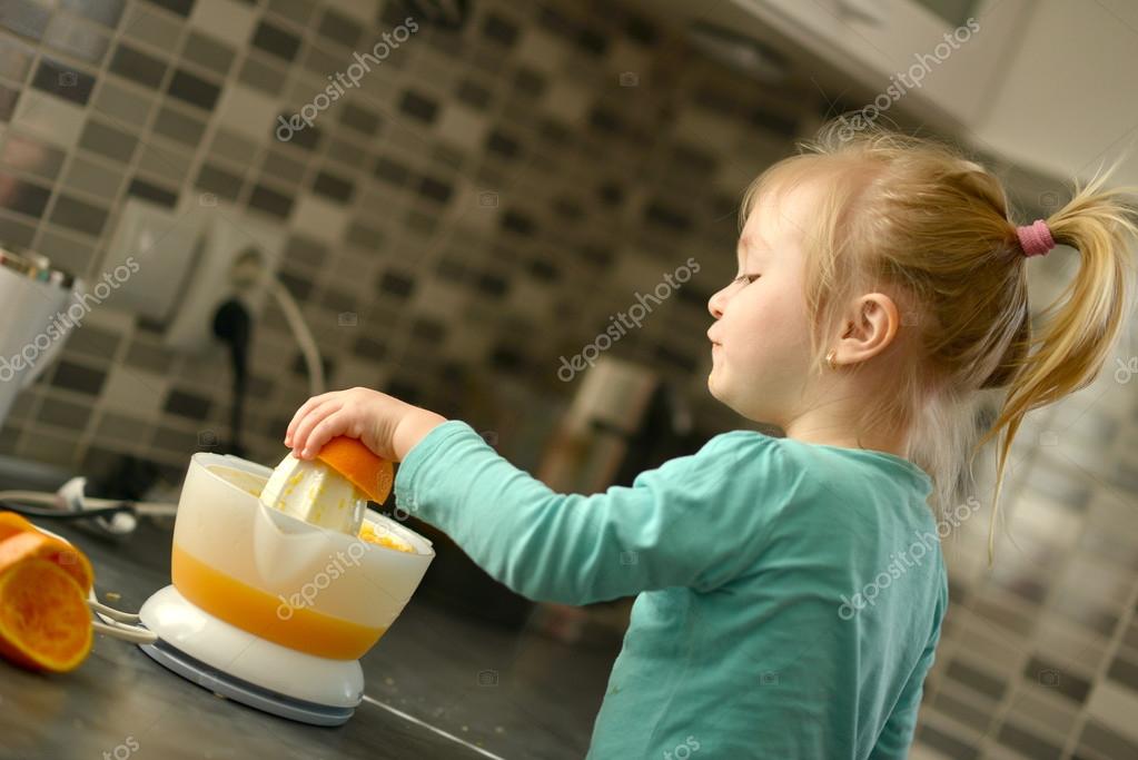 Child making fresh orange juice Stock Photo by ©muro 43175617