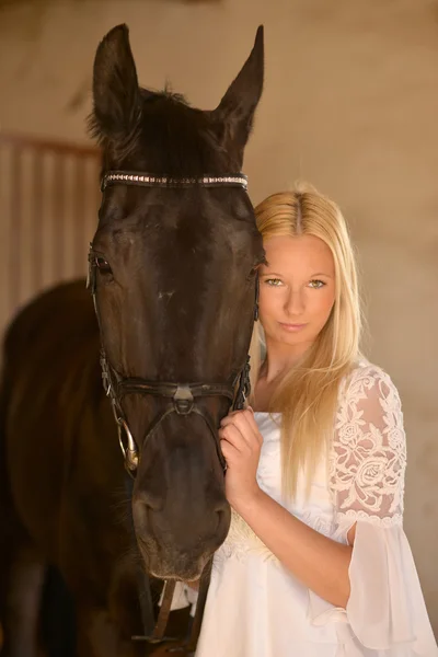 Dark horse and woman — Stock Photo, Image