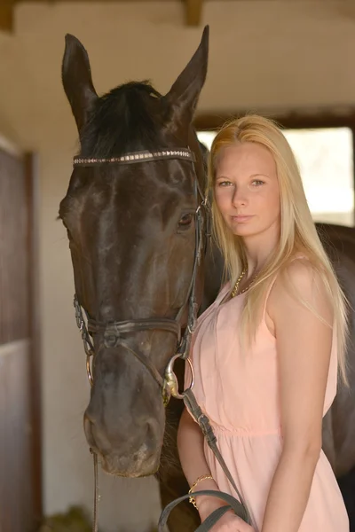 Dark horse and woman — Stock Photo, Image