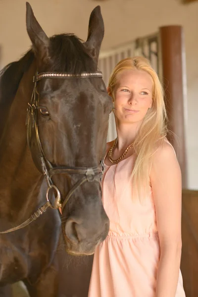 Dark horse and woman — Stock Photo, Image