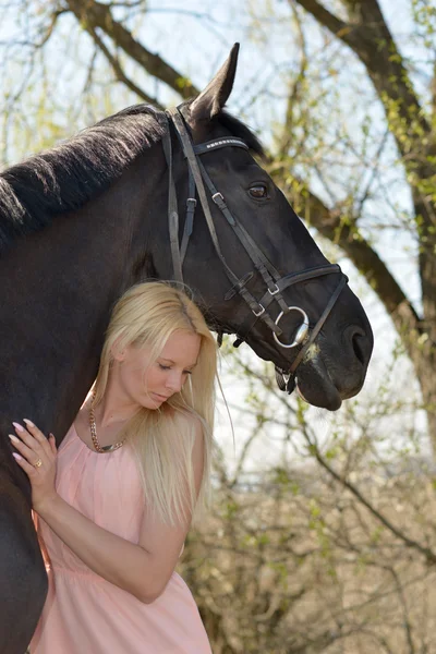 Dark horse and woman — Stock Photo, Image