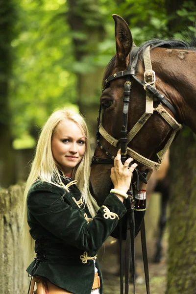 Dark horse and woman — Stock Photo, Image