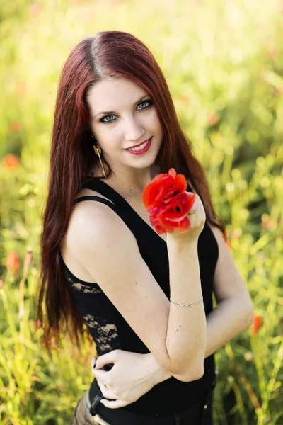 Woman holding a poppy flower — Stock Photo, Image