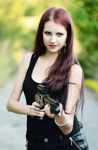 Sexy Woman holding Handgun in hand — Stock Photo, Image