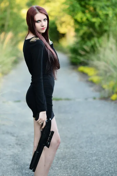 Sexy Woman holding Handgun in hand — Stock Photo, Image