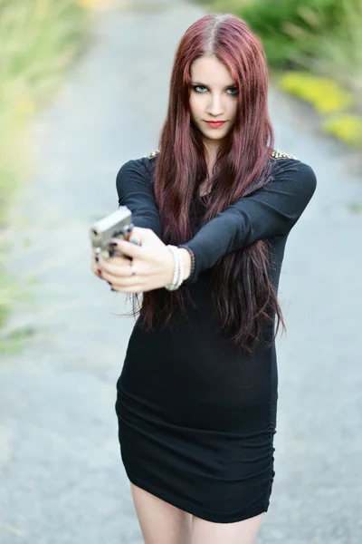 Sexy Woman holding Handgun in hand — Stock Photo, Image