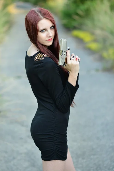 Sexy Woman holding Handgun in hand — Stock Photo, Image