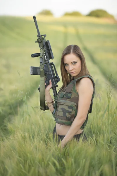 Sexy woman holding up her weapon — Stock Photo, Image