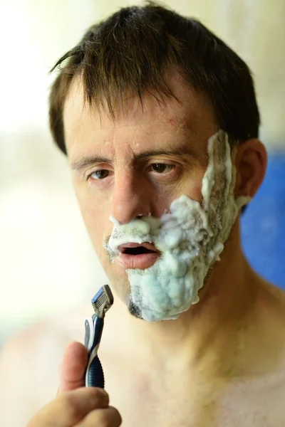 Down syndrome man shaving — Stock Photo, Image