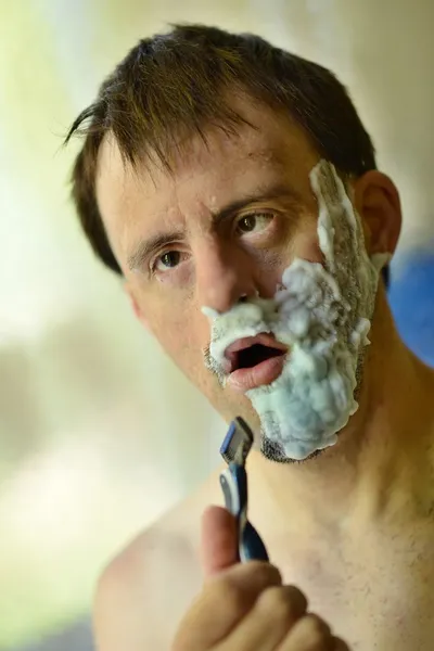 Down syndrome man shaving — Stock Photo, Image